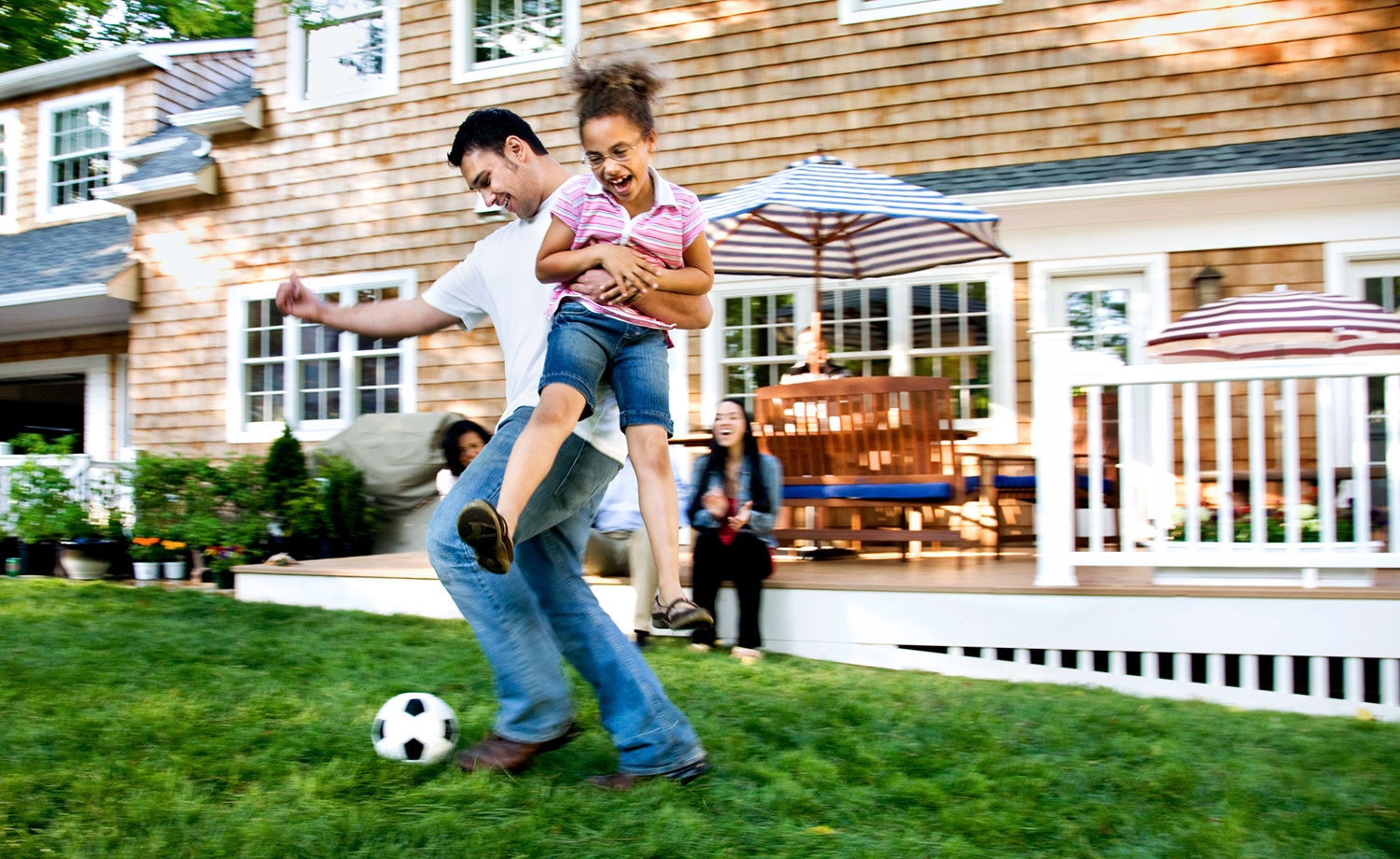 Family playing soccer.