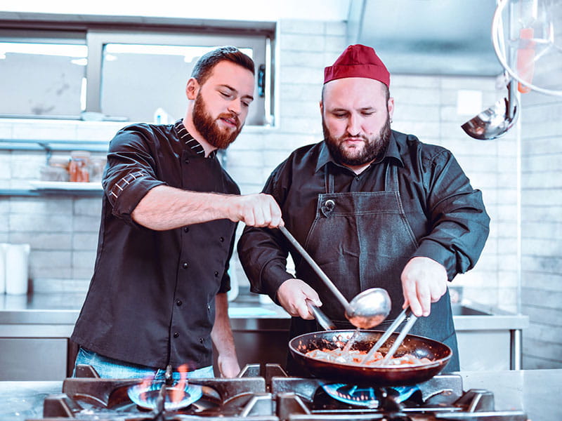 Two chefs cooking.