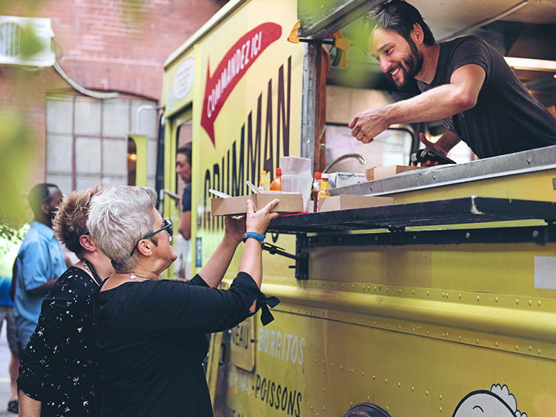 Customer getting order from food truck.