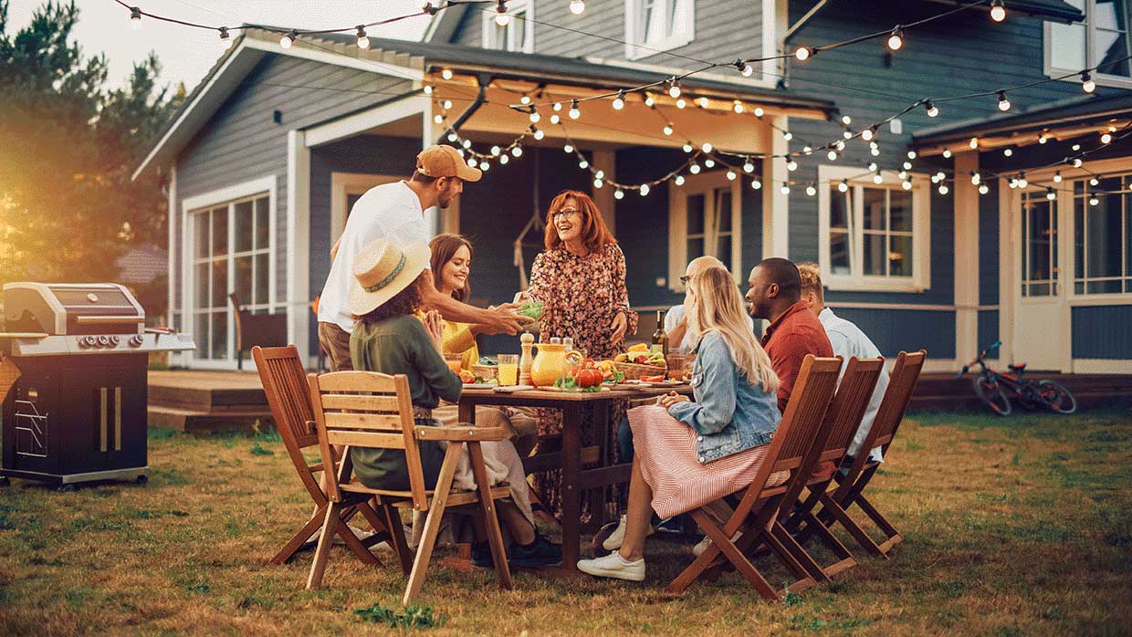 family dining outside in backyard