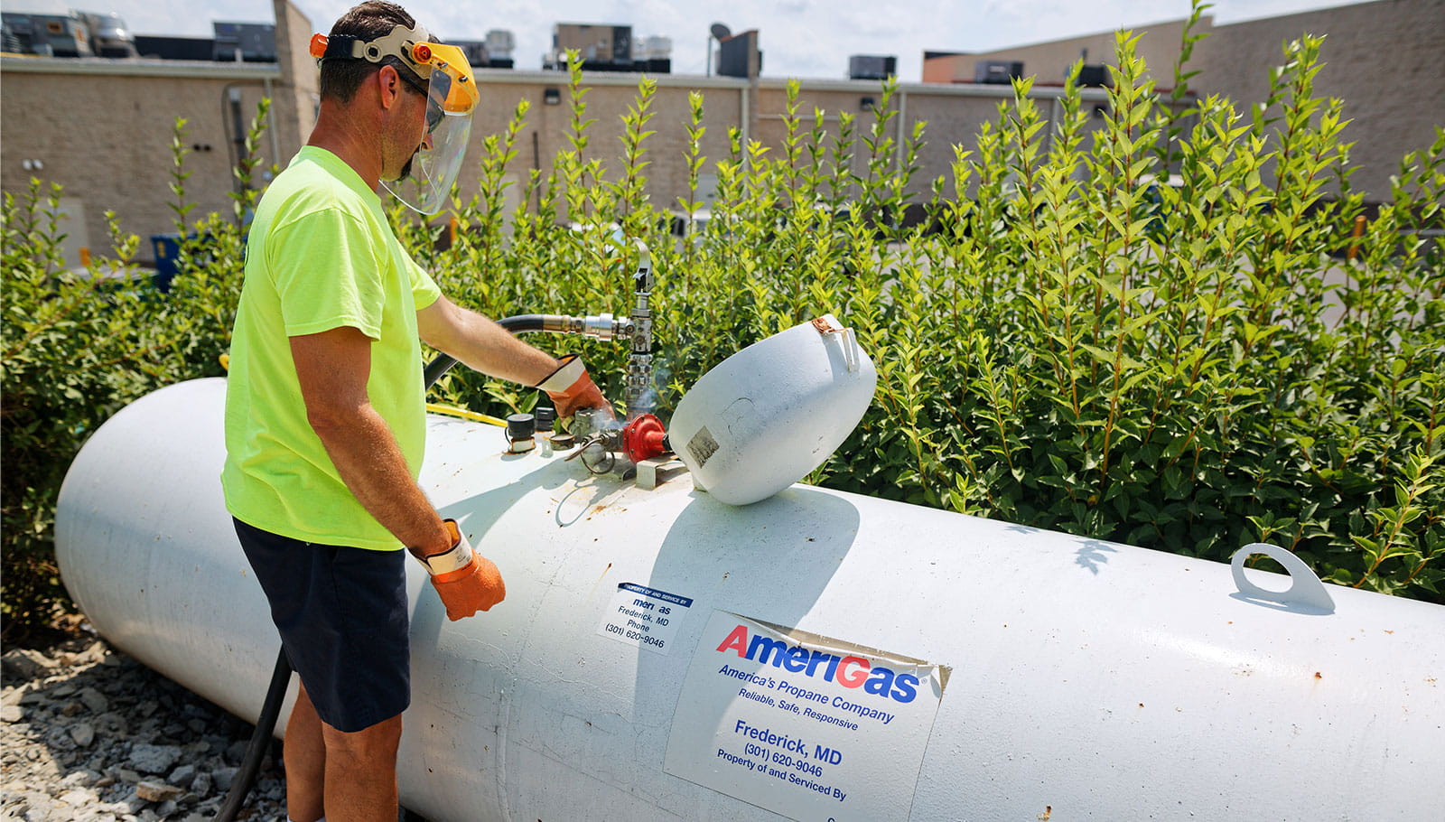 Worker filling propane tank