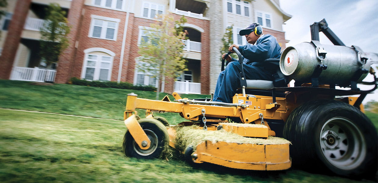 Propane lawn mower in use.